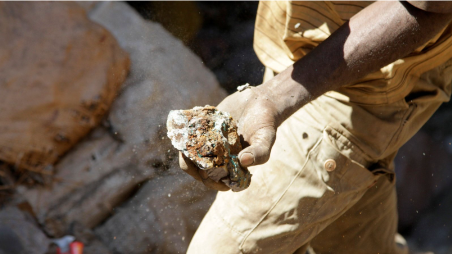 Man holding cobalt in his hand