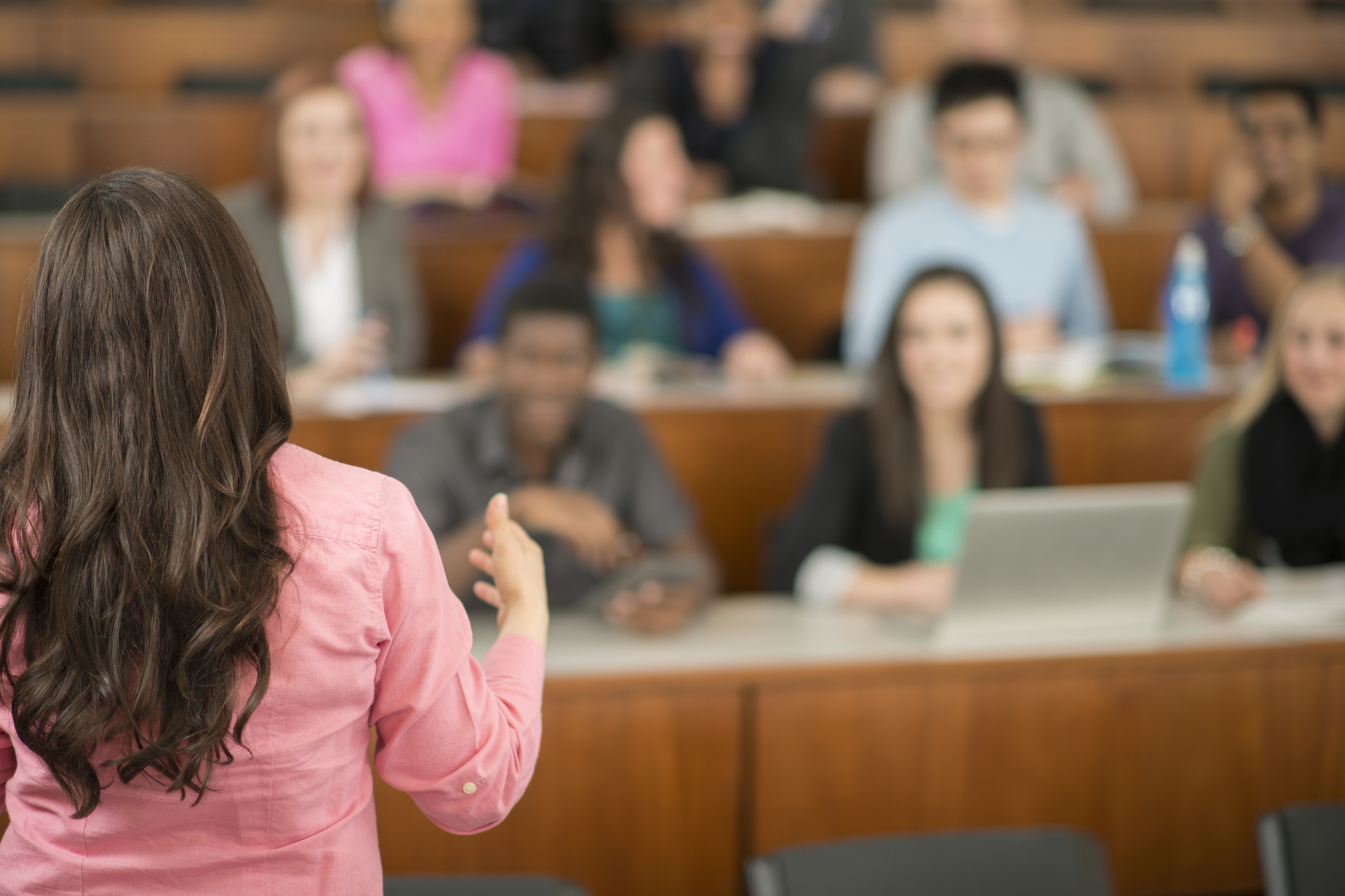 Teacher’s back in front of sitting students